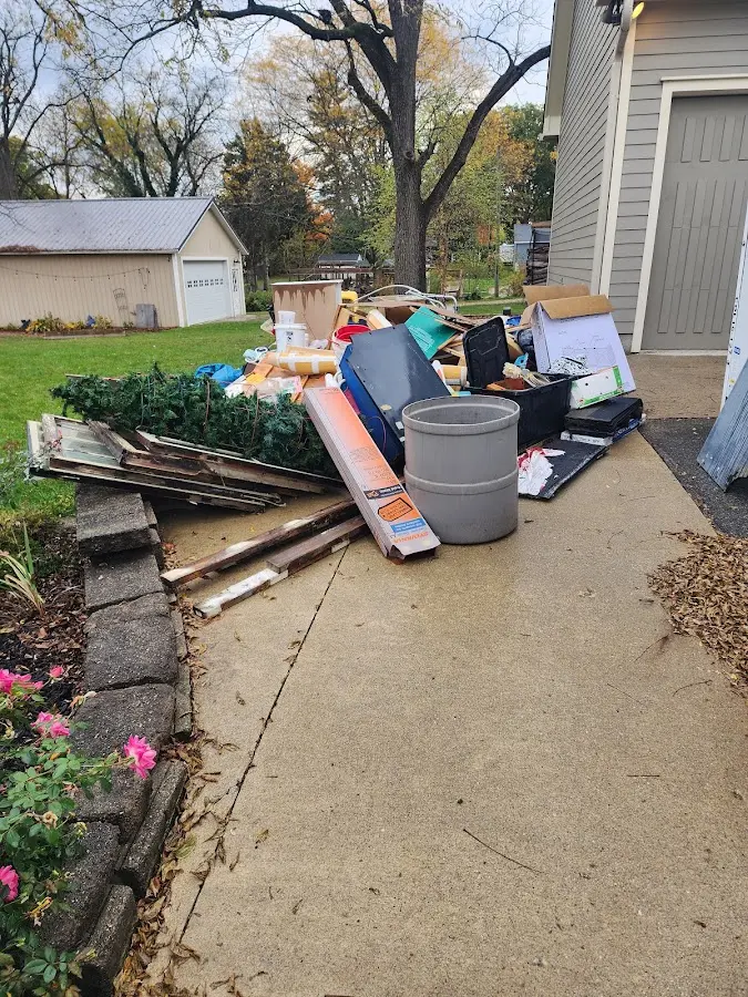 Dumpster being loaded with debris for Estate Cleanout Dumpster Rental in Sudden Valley